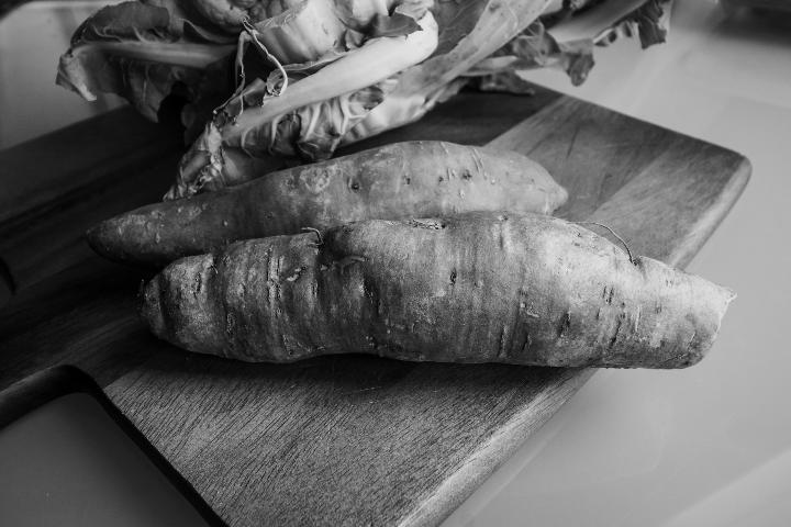 grayscale photo of raw fish on wooden table